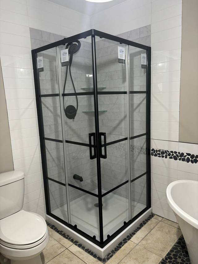 Douche vitrée à grille noire et plancher à motifs